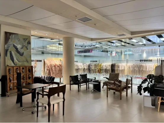 YXX Fabric Guangzhou showroom with fabric sample racks and buyer seating